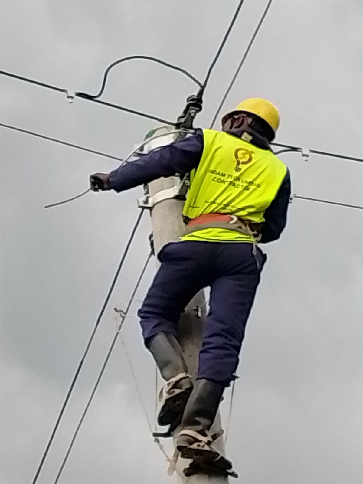 Gigam Tech lineman working on an overhead power line
