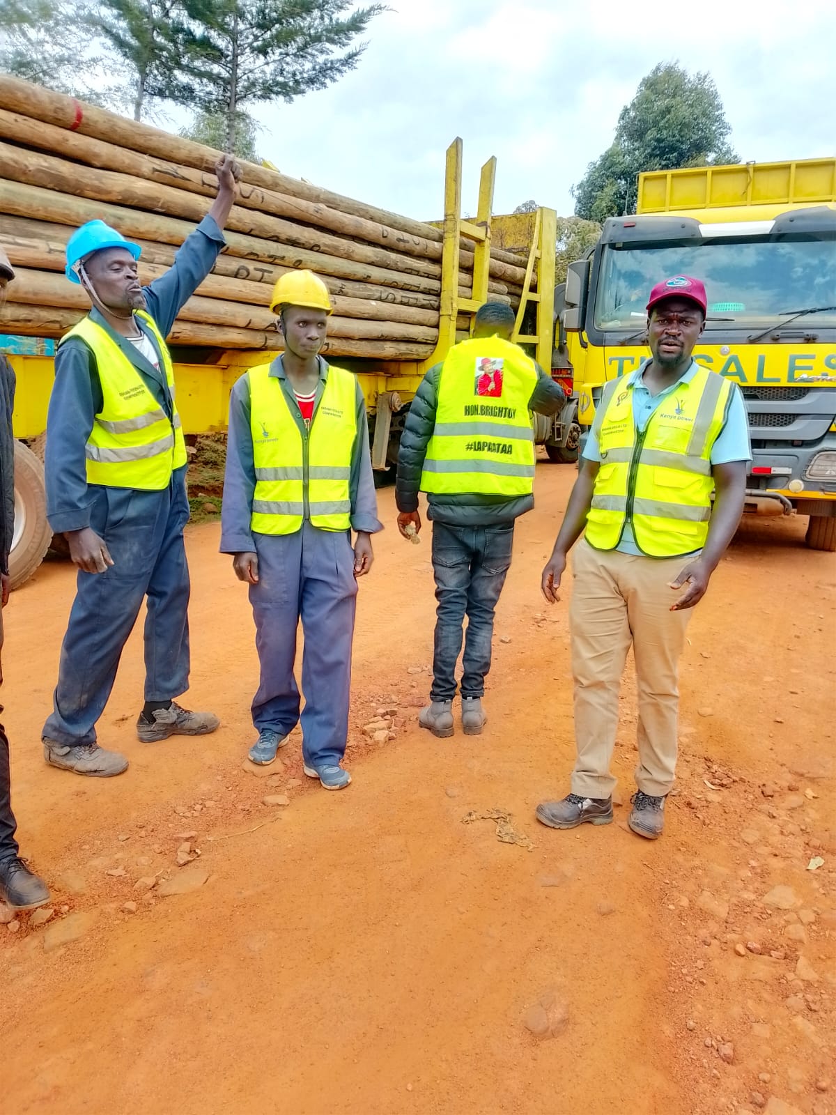 The Gigam Tech team on site beside a truck loaded with power poles